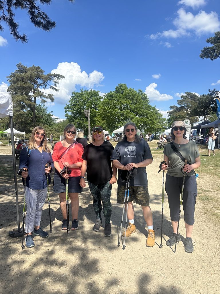 5 people holding nordic walking poles